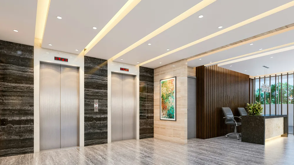 Modern building lobby with elevators, a reception desk and polished stone floors